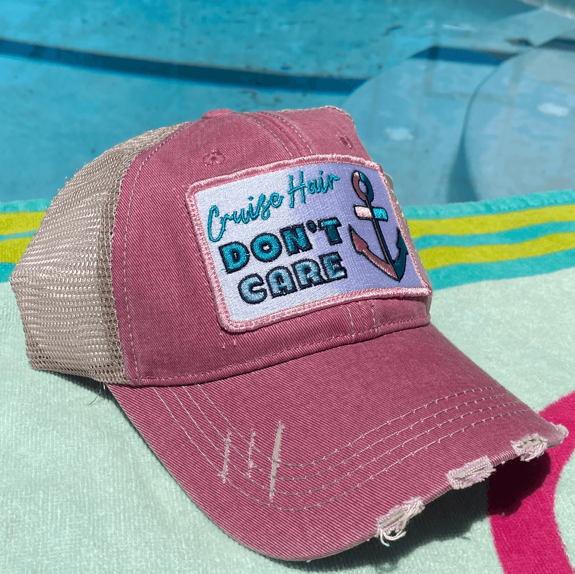 a pink trucker hat with a patch on it