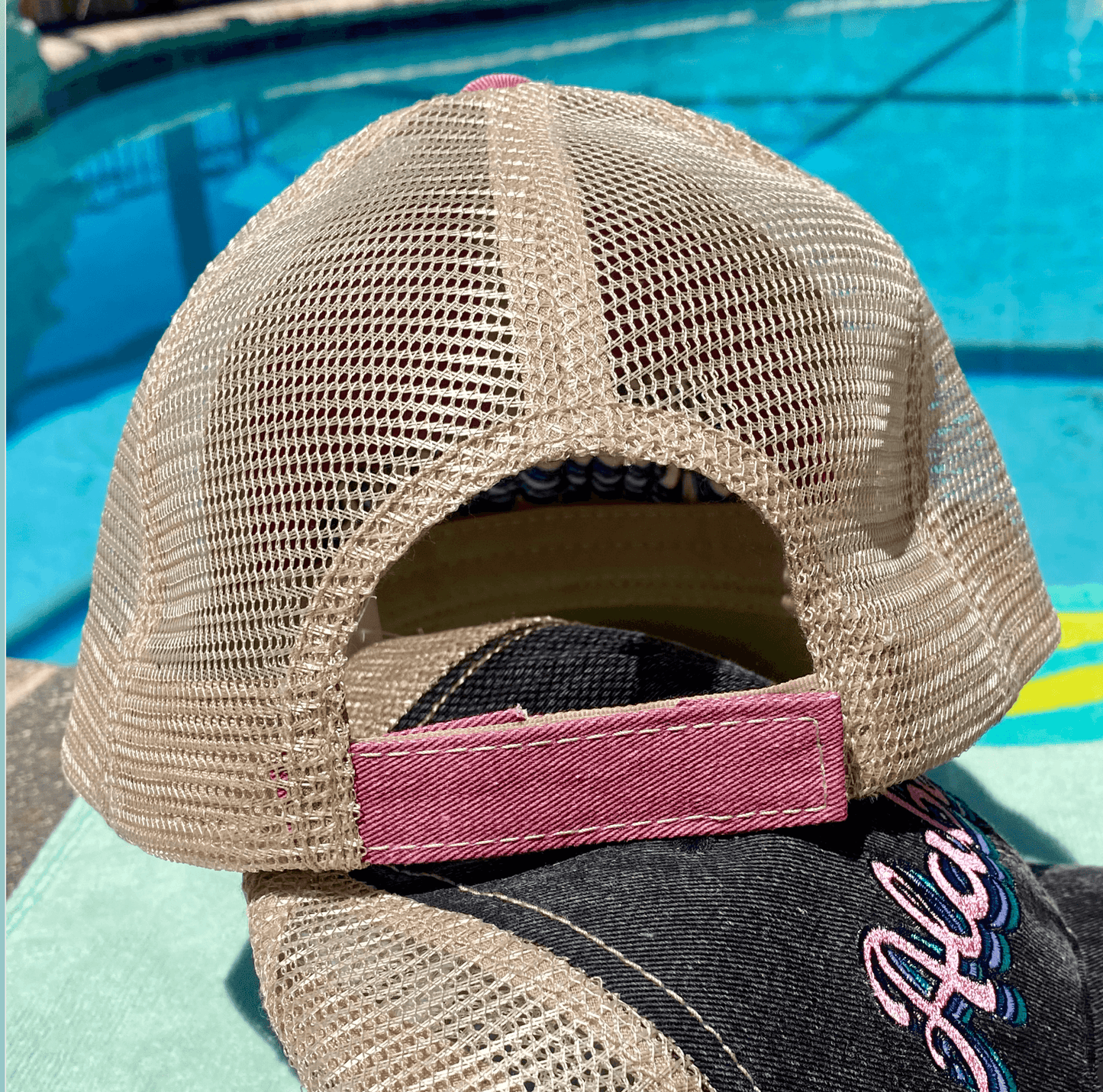 a hat sitting next to a swimming pool